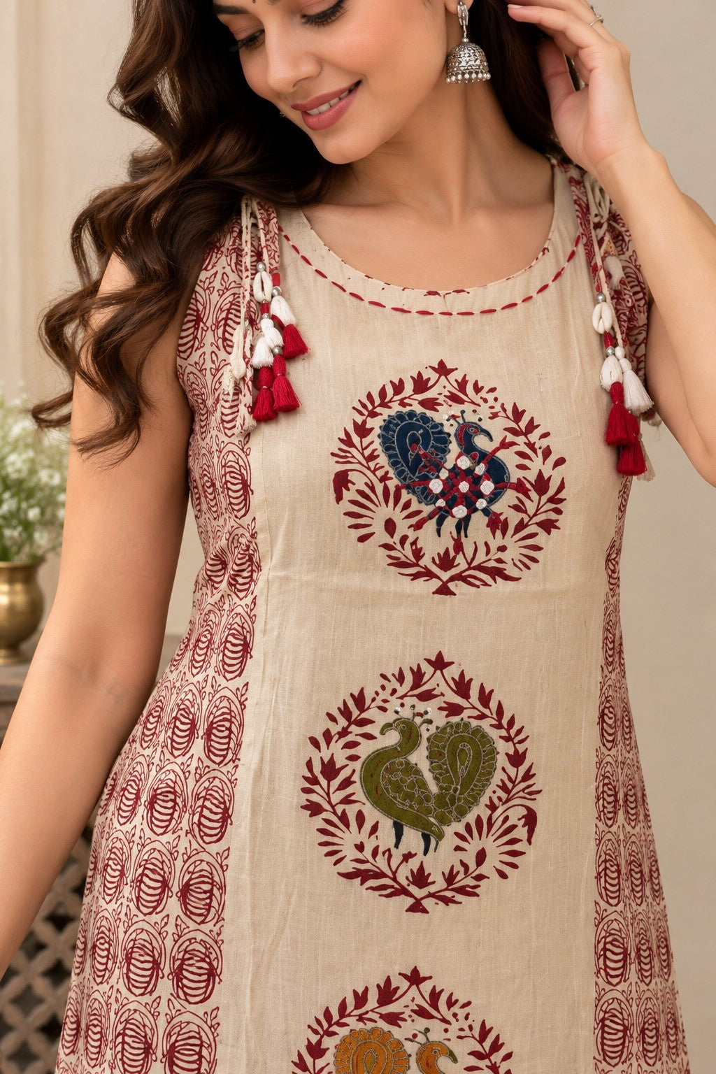 Beige sleeveless straight kurta with floral paisley print and tassels